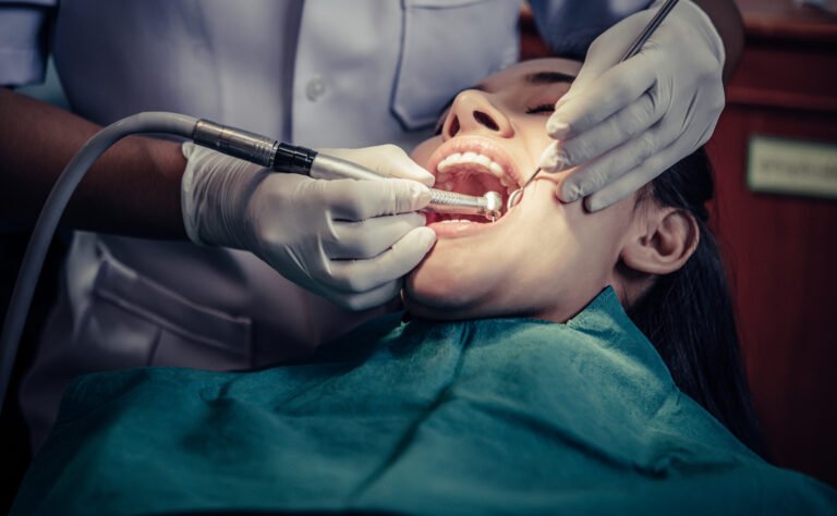 dentist-using-dental-drill-on-patient