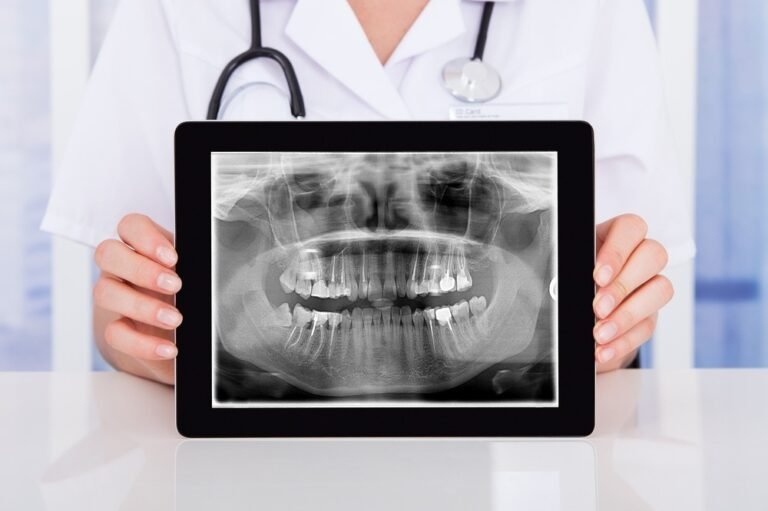 dentist-holding-tablet-showing-panoramic-x-ray
